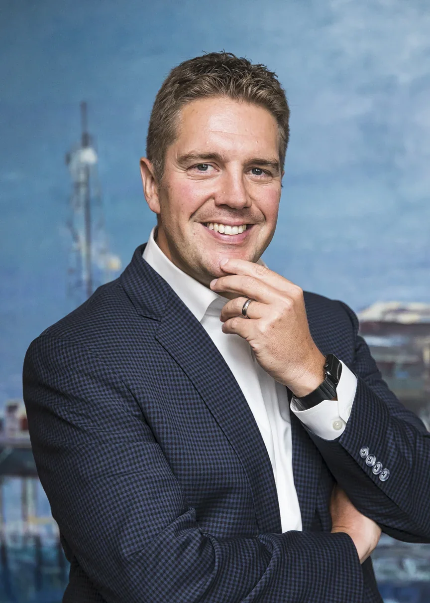 Professioneel headshot van een man met havenkranen op de achtergrond